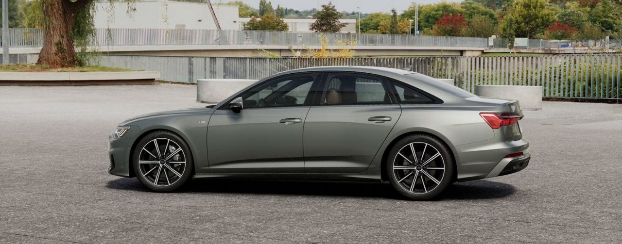 Grey 2025 Audi A6 parked near a bridge